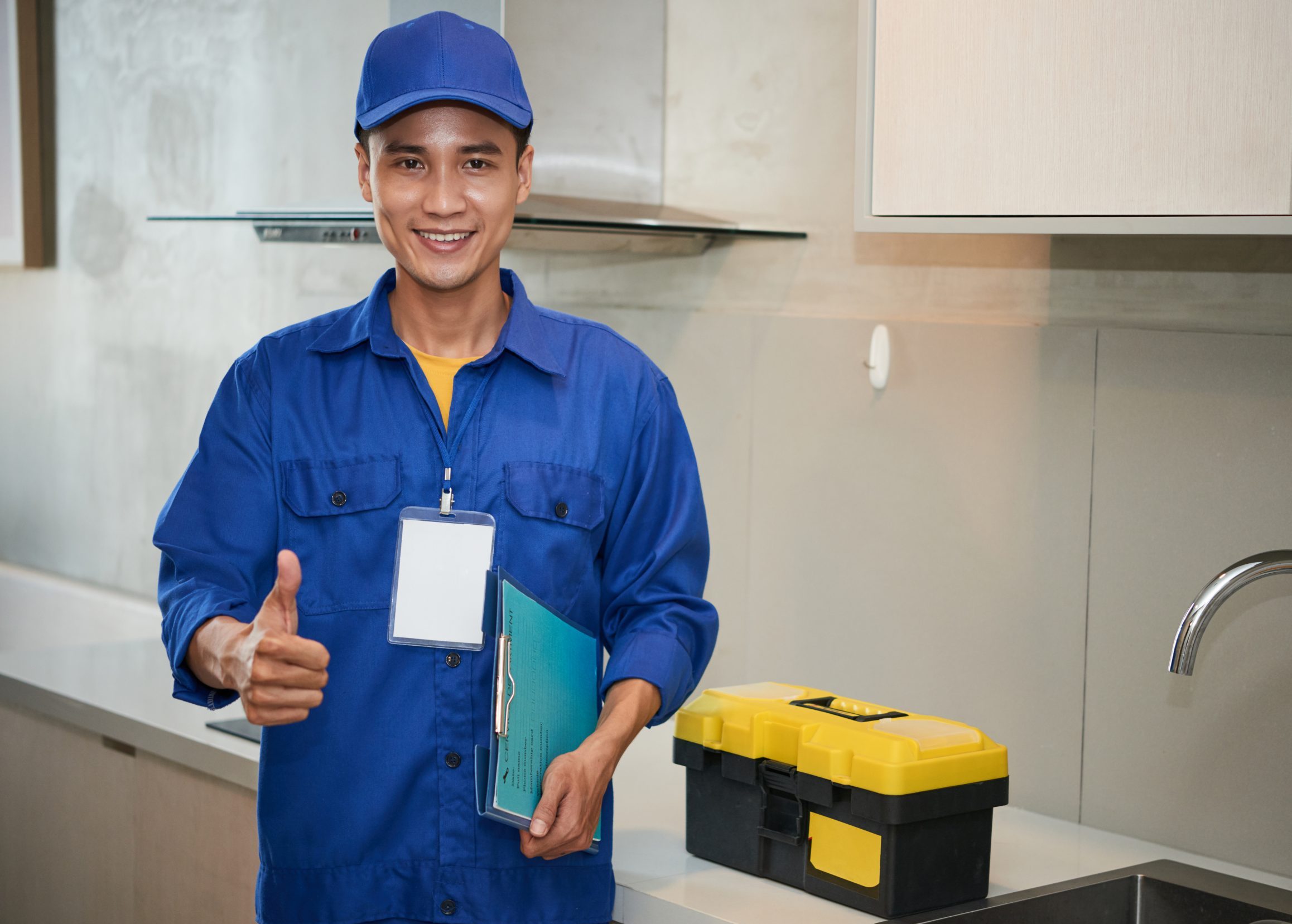 Photo of smiling AC technician illustrates blog: "When Should I Schedule AC Tune-Ups in 2022?"