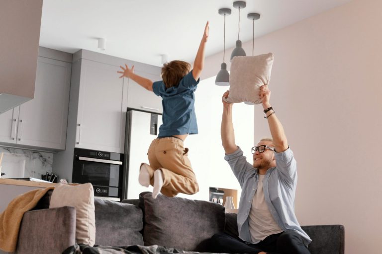 Adult and child playing in living room illustrate blog "5 Ways To Help Your AC on Hot Days"