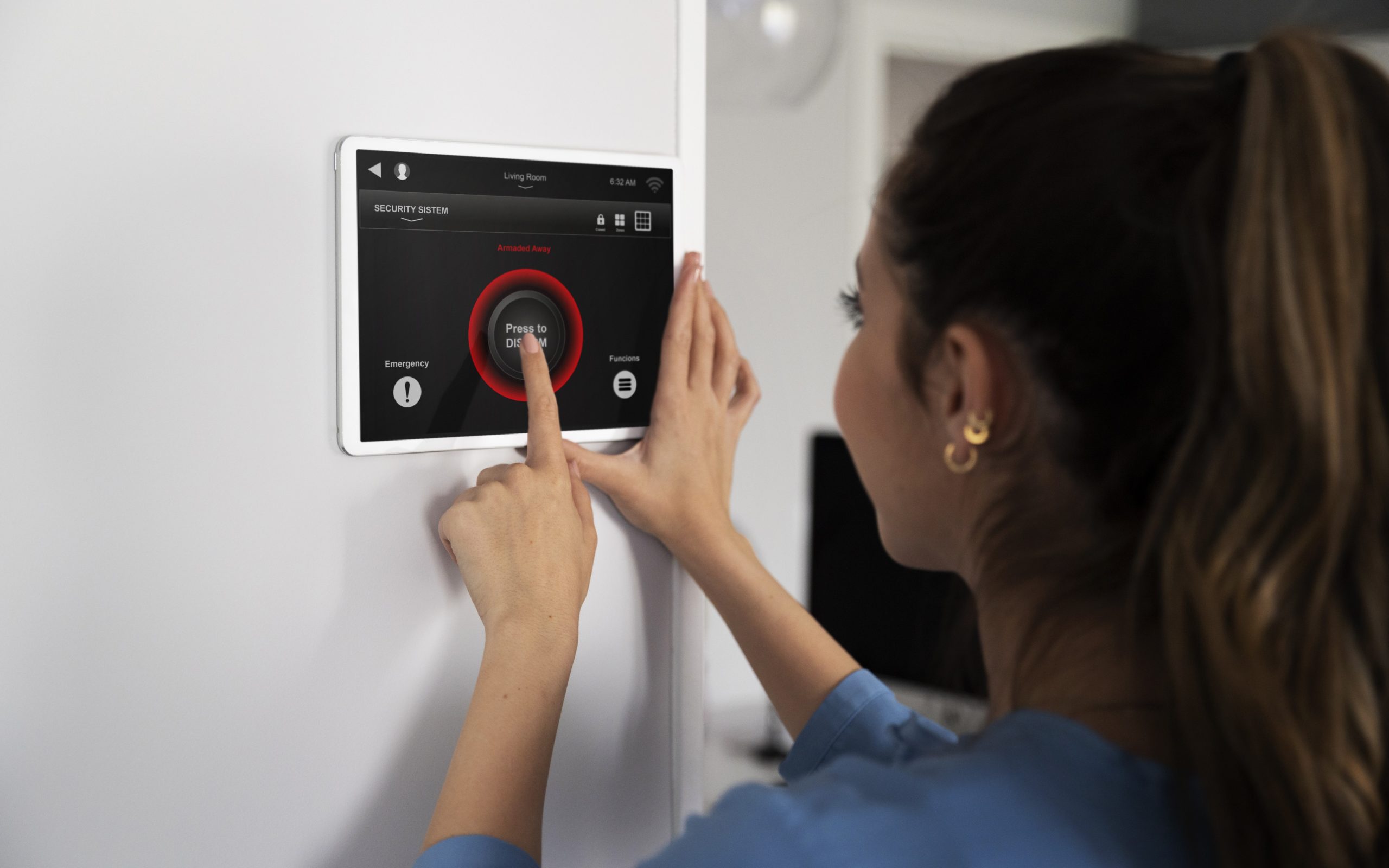 Woman using digital thermostat illustrates blog "5 Signs Your AC Needs Cleaning"