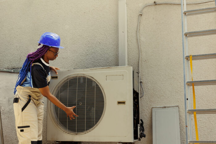 Worker dissasembling air conditioner