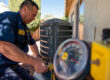 technician performing early AC maintenance on air conditioning unit