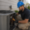 HVAC technician improving central AC efficiency before summer