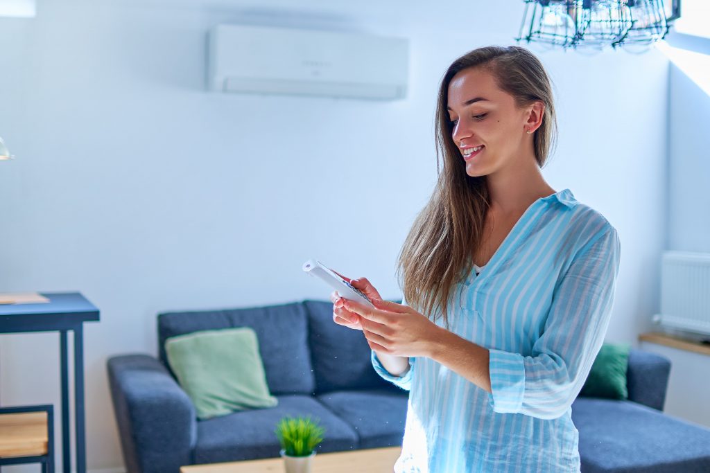 Image of woman holding AC remote control illustrates blog "More AC Tips and Ideas These are some previous posts you can check out for more ideas, and interesting facts about your air conditioning system: 4 Reasons to replace your AC filters frequently How to tell when it’s time to replace your Air Conditioning 9 Common HVAC Terms You Should Know 4 Benefits of programmable thermostats Need Help Repairing Your Air Conditioning in San Antonio, TX? When it comes to installing, repairing, maintaining, and replacing all brands of residential HVAC in San Antonio Texas, Zero Heating and Refrigeration is your best option. We are located at 4142 Hickory Sun, San Antonio, Texas. Contact us today using our website, by telephone (210-900-0824), or through our social media accounts on Facebook and Twitter and to schedule a repair or to get a free estimate. We also offer financing plans for your convenience!"