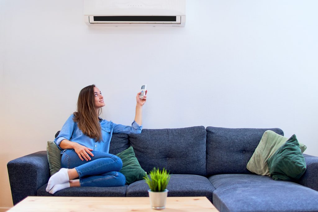 Photo of girl with air conditioning illustrates blog: "MERV Rating for AC filters: What You Need to Know"