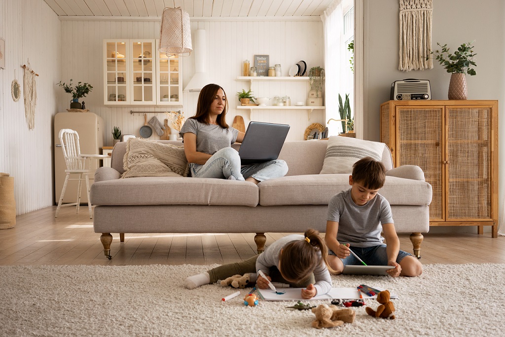 Mother and two children in living room illustrates blog "What Causes Mold on AC Coils?"
