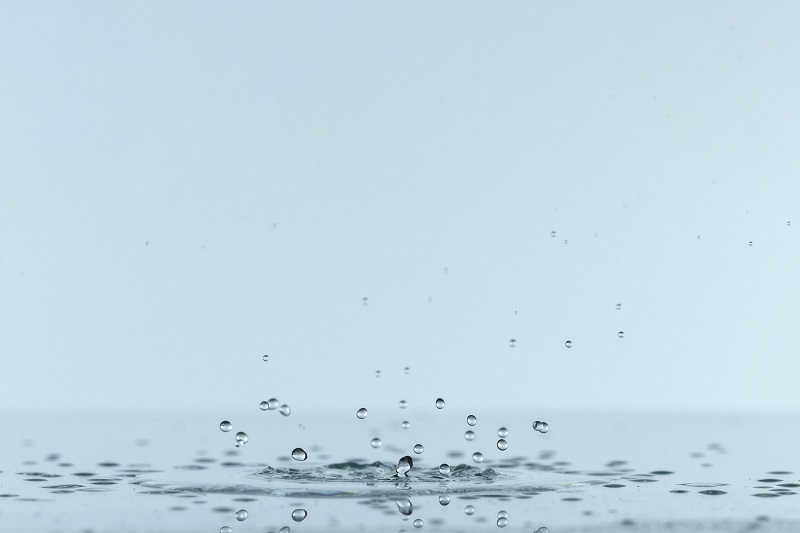 Closeup of drops of water falling.